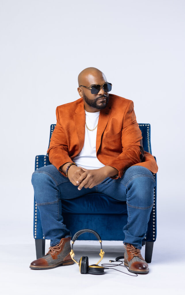 DJ Drake sitting deep orange blazer